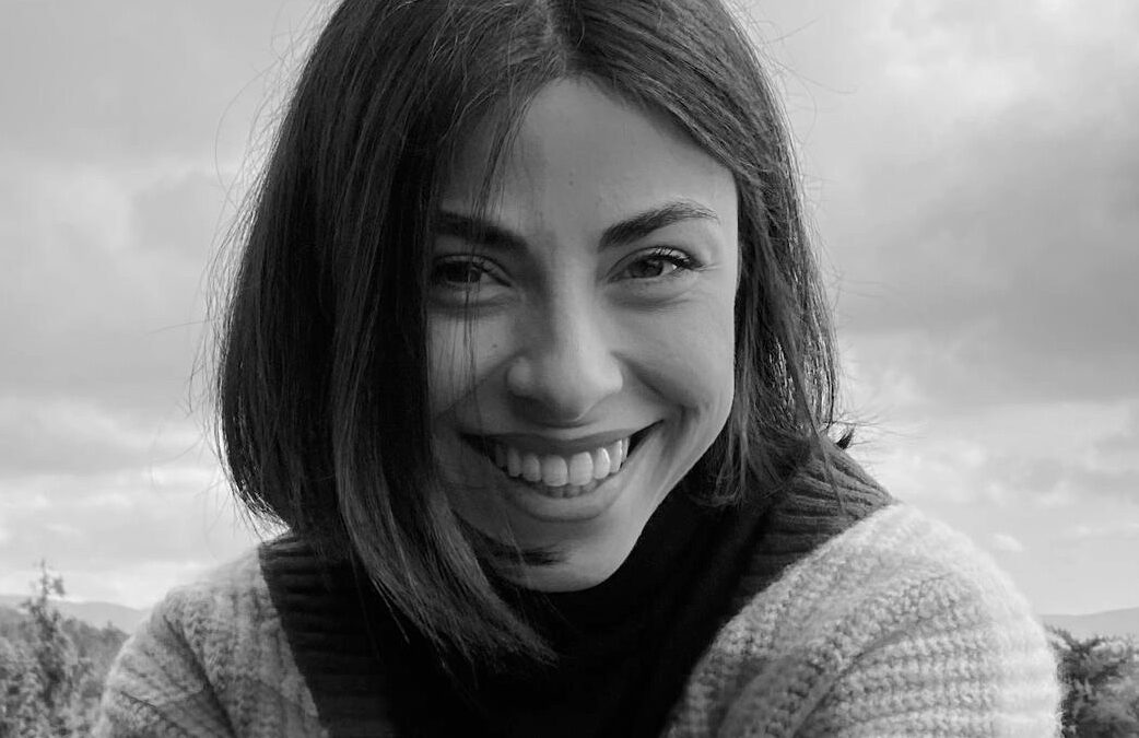 Alexandra Koziaki laughing, outdoors.