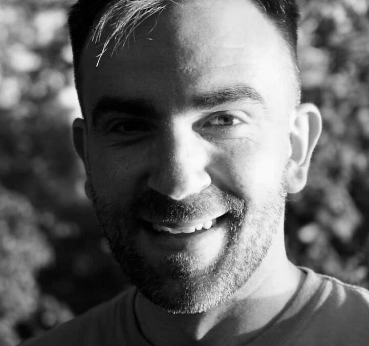 Vaios Kolofotias smiling, in sunlight.