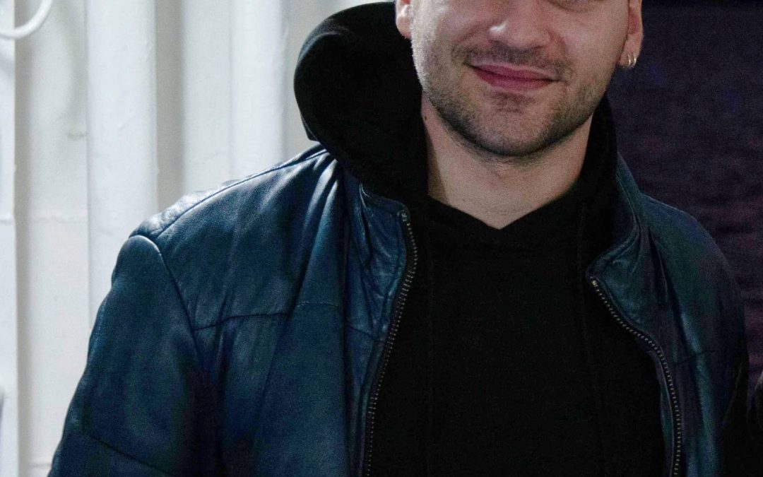 Ilias Papagiannis lächelt, in Lederjacke.
