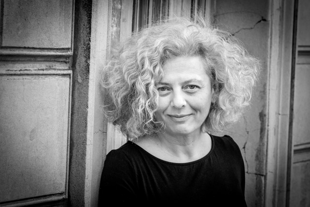 Niki Lambrianidou lächelt, mit grauen Locken.